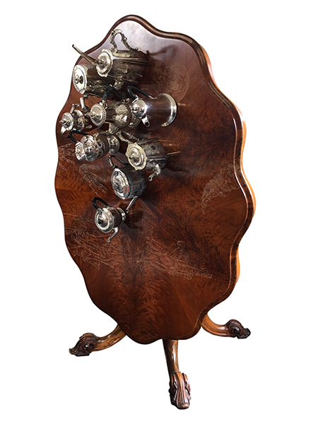 Megan Evans, The Whispering in our Hearts, 2018<br/>Victorian antique mahogany tilt top table, antique silver tea pots, coffee pots, brass fixtures, dimensions variable